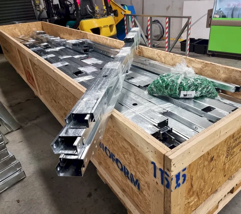 Labelled light gauge steel framing components packed in a timber crate for shipping